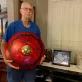 Dad holding the ride cymbal  next to a picture of mom